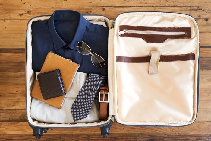 Airline travel tip man's suitcase packed