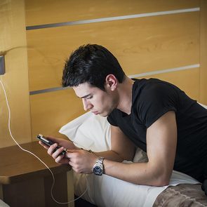 manwithphoneonbed