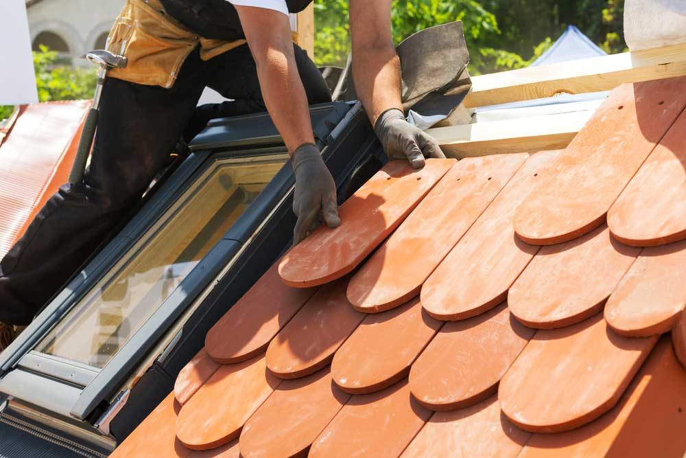 man replacing roof after hurricane