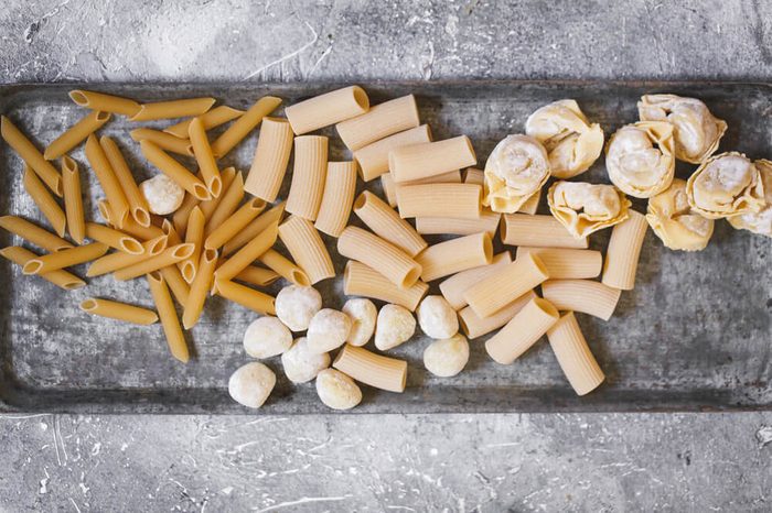 raw italian pasta variety overhead uncooked gluten free pasta on baking dish 