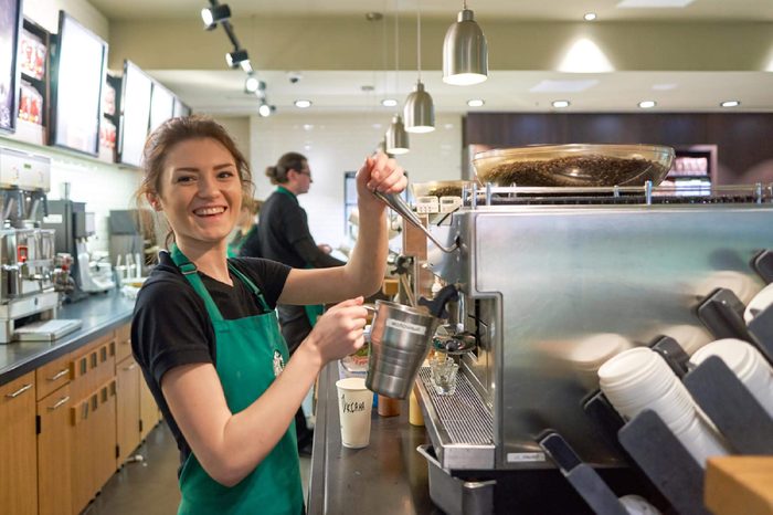 SAINT PETERSBURG, RUSSIA - MARCH 12, 2016: worker at Starbucks Cafe. Starbucks Corporation is an American global coffee company and coffeehouse chain based in Seattle, Washington