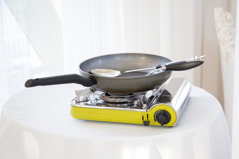 Portable gas stove on the table in restaurant.