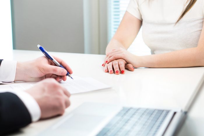 Young woman in job interview with business man. Interviewer writing notes. Lady having meeting with boss or executive manager.