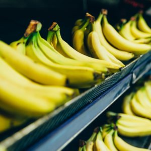 yellow bananas on store shelf. fruits grocery shopping