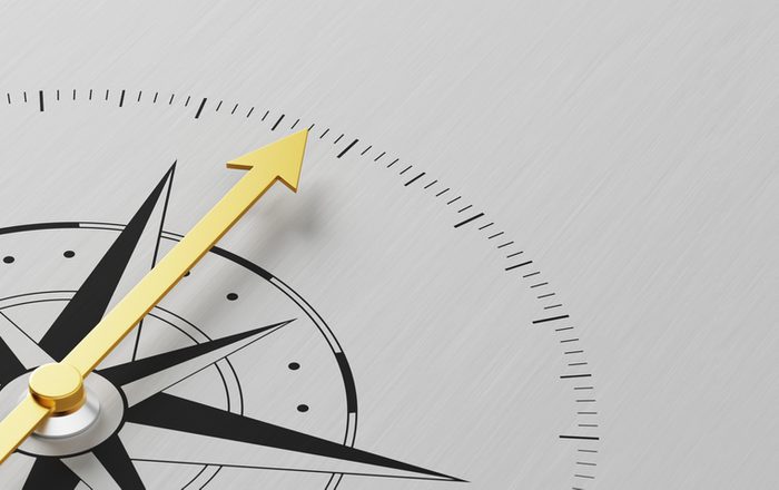 A Compass on a metal background with copy space