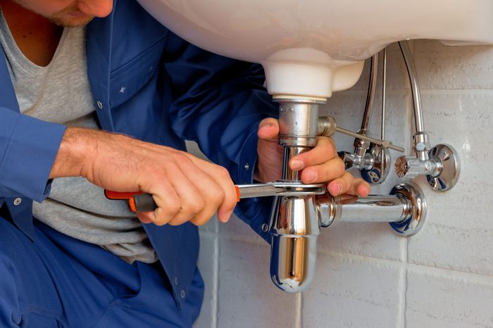a plumber at work in a bathroom