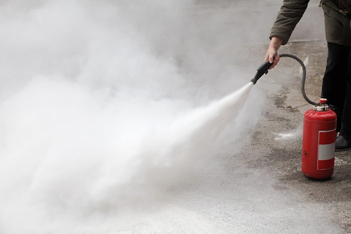 demonstrating how to use a fire extinguisher