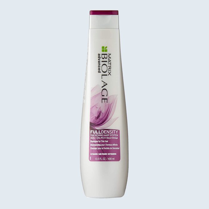Bottle stands upright, displaying Matrix Biolage FullDensity shampoo, with purple floral design, labeled for thickening hair system. Text reads 13.5 FL OZ / 400 ml.