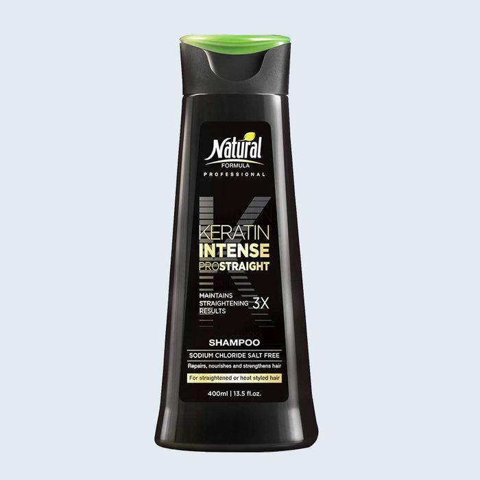 Bottle of keratin shampoo stands against light background, labeled 
