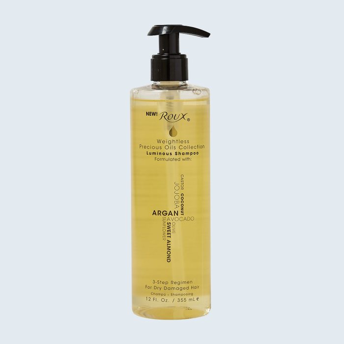 A clear bottle with a black pump contains Roux weightless shampoo, surrounded by a light background, designed for dry, damaged hair.