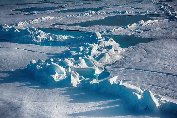 North Pole (88-90 degrees) in 2016. Summer snow morass (melt water pool) and toros (haycock, multi-year ice hummock) on ice of Arctic ocean. Global warming: Ice at North pole will melt in few decades