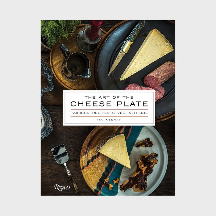 Cheese wedges on plates with a knife, salami, and garnishes; text reads 