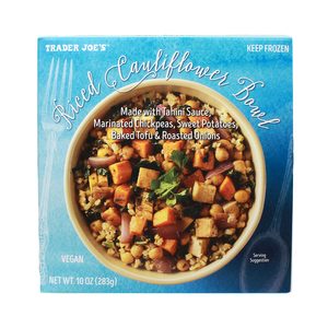 Bowl holds mixed vegetables and tofu, presented in blue packaging for a vegan riced cauliflower meal; features ingredients and 