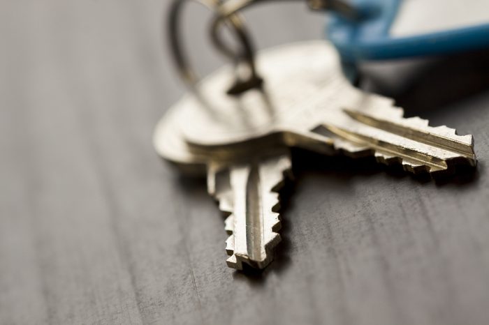 Macro Shot of Conceptual House Keys on Top of Wooden Table