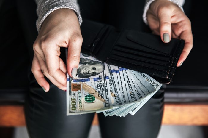 A lot of money in female hands. Business. Dollars and prosperity.
