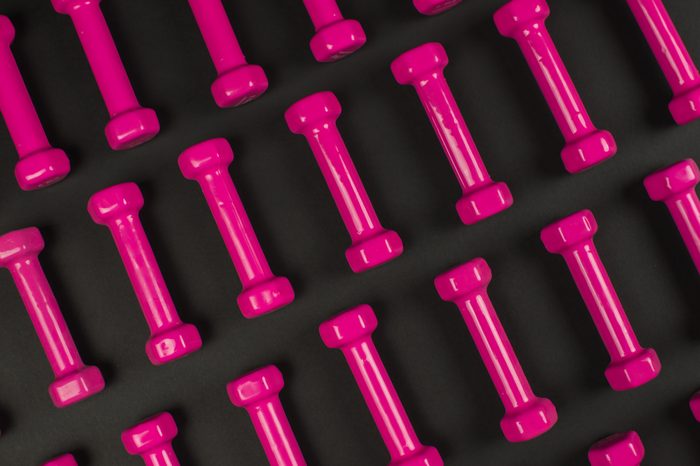 pink dumbbels isolated on black.