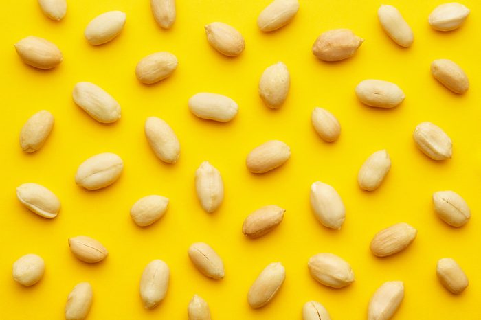 Peanuts pattern isolated on a yellow backround. Repetition concept. Top view