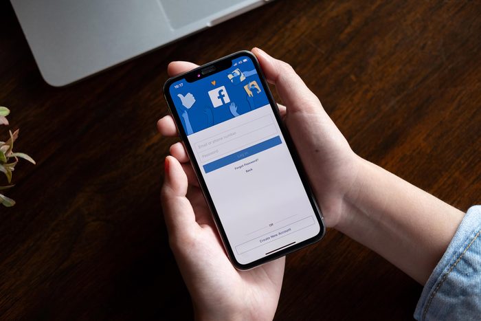 phone hands facebook app