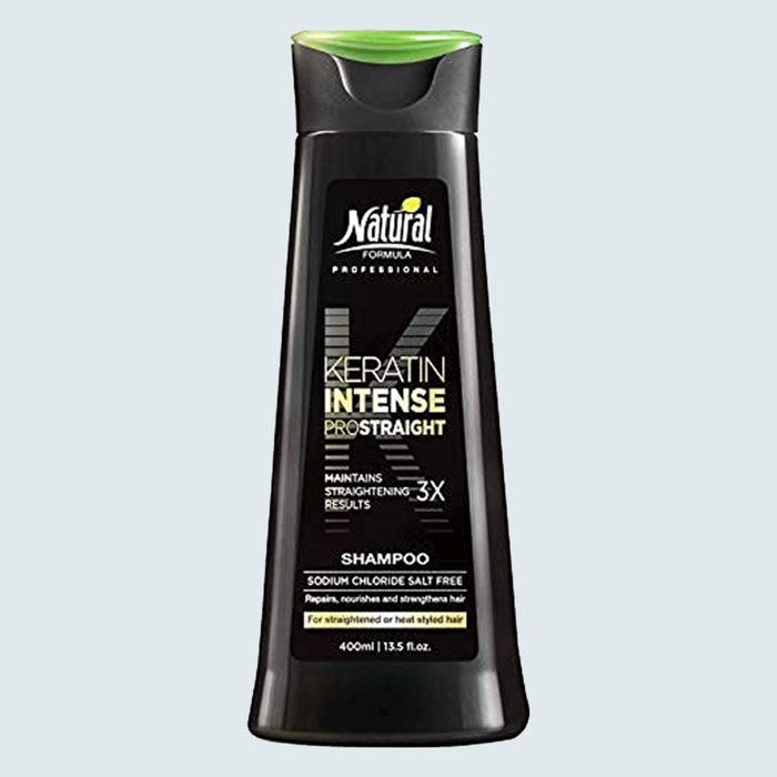 Black shampoo bottle stands upright, displaying 