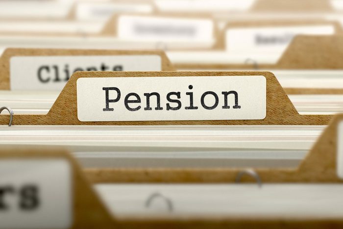 File tab labeled "Pension" stands upright among other file tabs in a drawer or filing system.