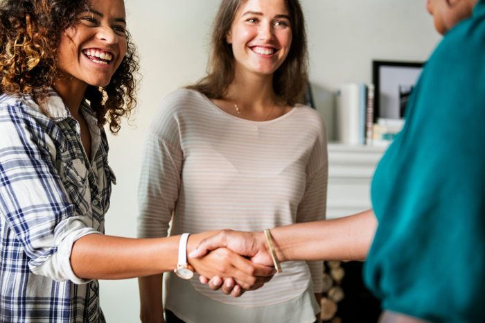 Diverse woman shaking hands