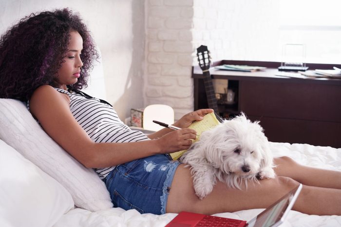 sitting with dog in bed