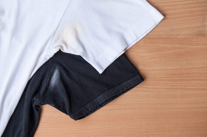 Shirts dirty caused by roll- on deodorant on wooden background