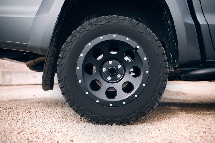 Suv car stopped at dirt road. Off road car wheel disassembly protection locked ring.