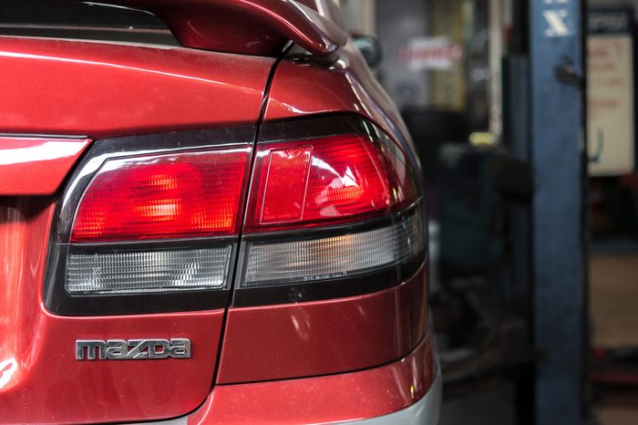 Bangkok, Thailand 14 May 2018 : Tail lights of red car that being repaired in a garage