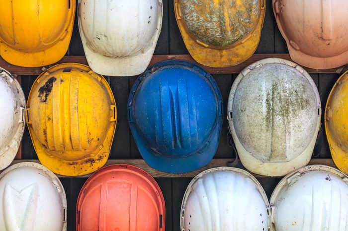 Old and worn colorful construction helmets