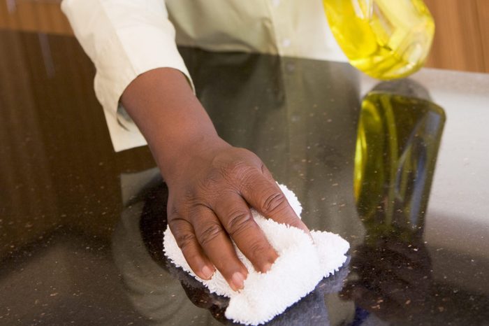 Woman Cleaning Kitchen Counter