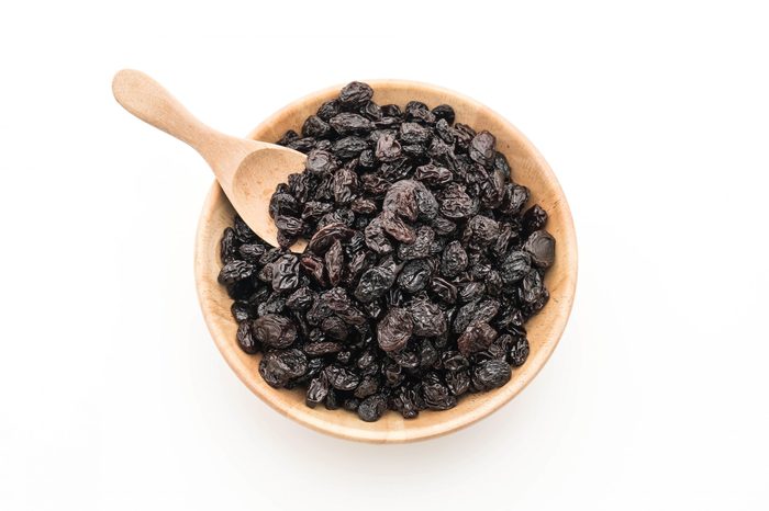 black raisins on white background