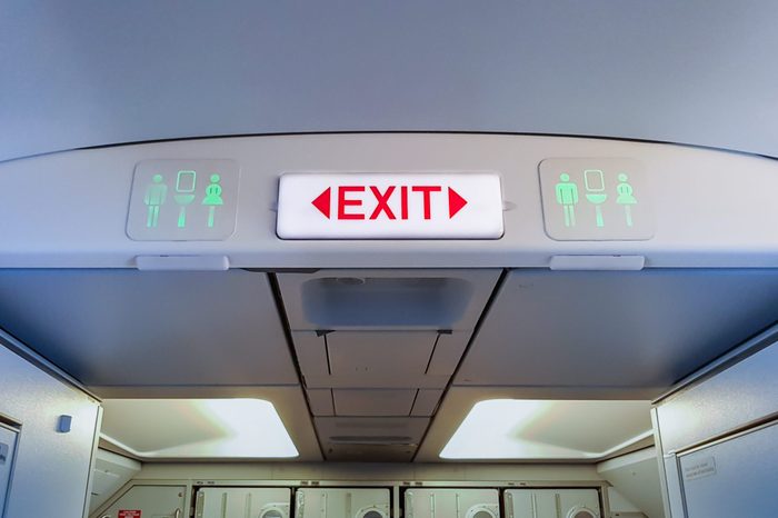 emergency exit sign and toilet sign on airplane