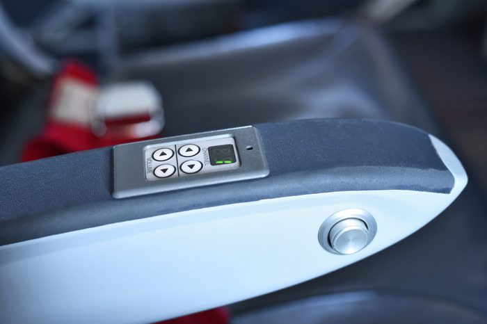 Airplane entertainment display on an arm rest inside the plane.