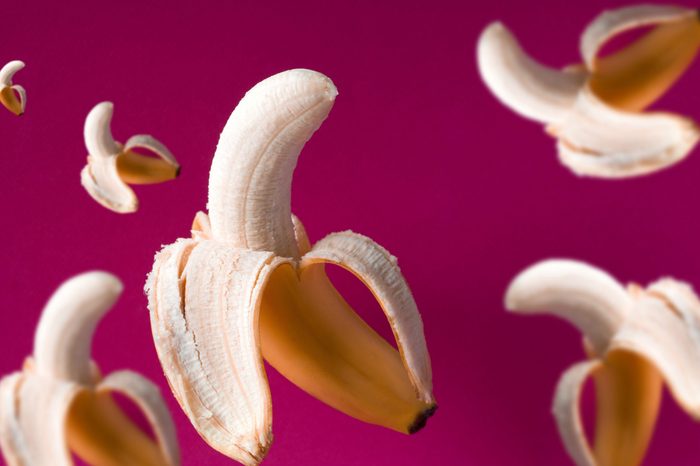 fresh flying bananas pattern on a vibrant pink background