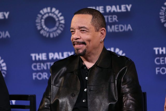 A person smiles while seated, wearing a black leather jacket. The backdrop displays "THE PALEY CENTER FOR MEDIA."