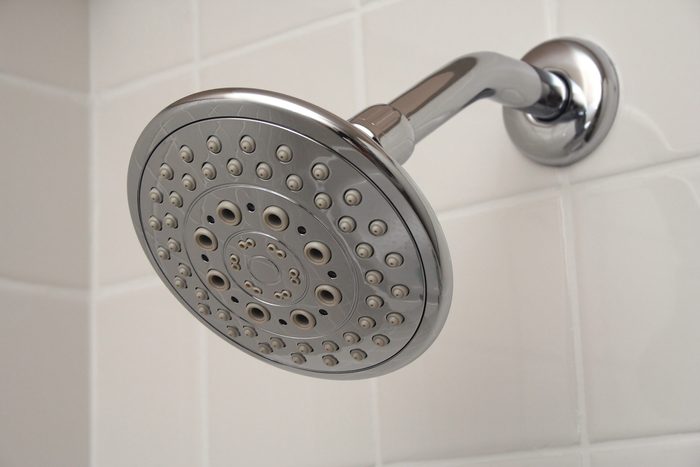 Chrome Massage Shower Head On White Tile Background