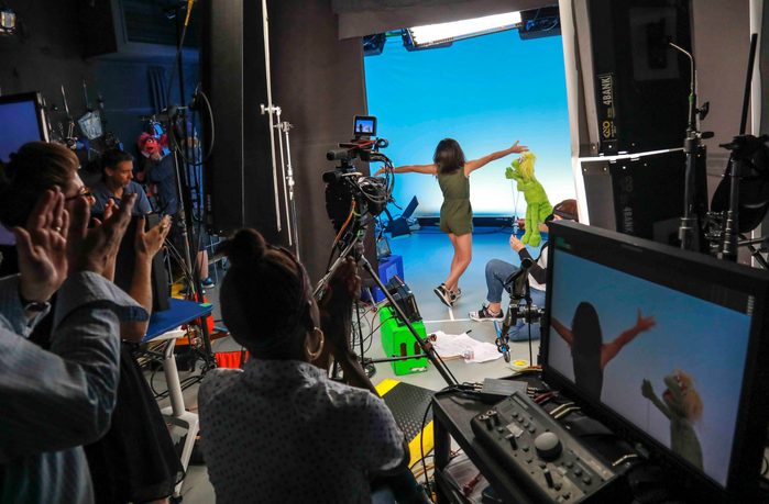 Mandatory Credit: Photo by Bebeto Matthews/AP/Shutterstock (10440203e) This photo shows production members clapping for Salia Woodbury, 10, left, from Irvine, Calif., on the set with "Sesame Street" muppet Karli and puppeteer Haley Jenkins during a taping about parental addiction in New York. Sesame Workshop is addressing the issue of addiction. Data shows 5.7 million children under 11 live in households with a parent with substance use disorder. Salia's parents are in recovery after struggling with addiction and share her experience with the show's Karli?whose muppet character has a mom who is also in recovery TV-Sesame Street-Addiction, New York, USA - 06 Aug 2019