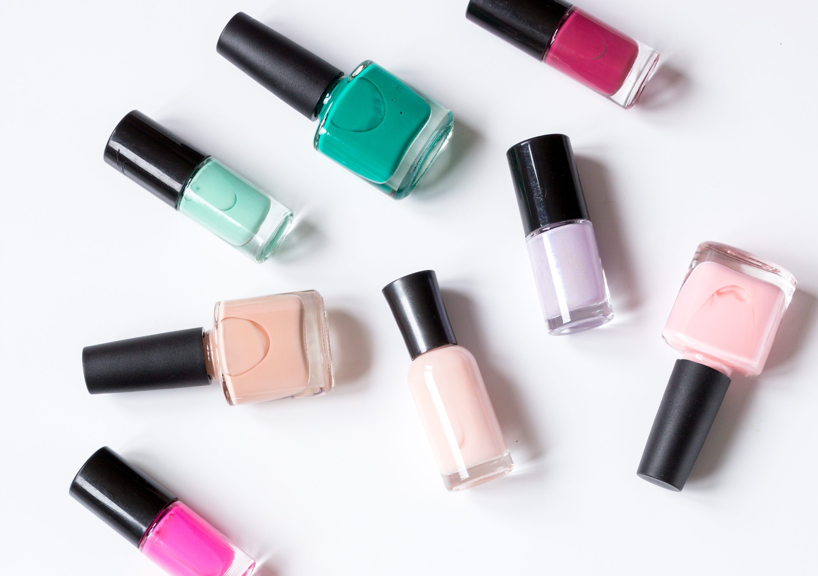 set for nail polish on white table background top view mock up