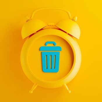 Yellow clock displaying a blue trash can icon against a solid yellow background.