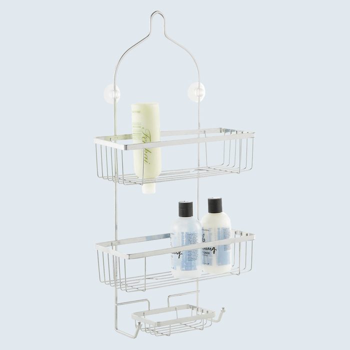 Metal shower caddy hanging, holding various bottles, in a bathroom setting.