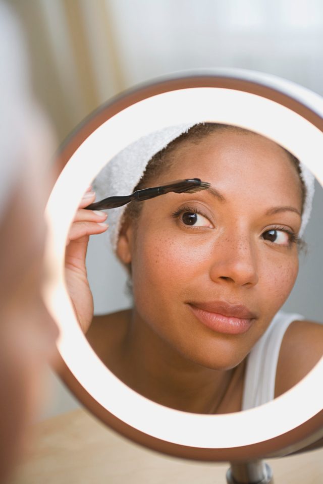 USA, California, Los Angeles, Woman brushing eyebrow
