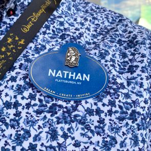 A blue name badge reads 