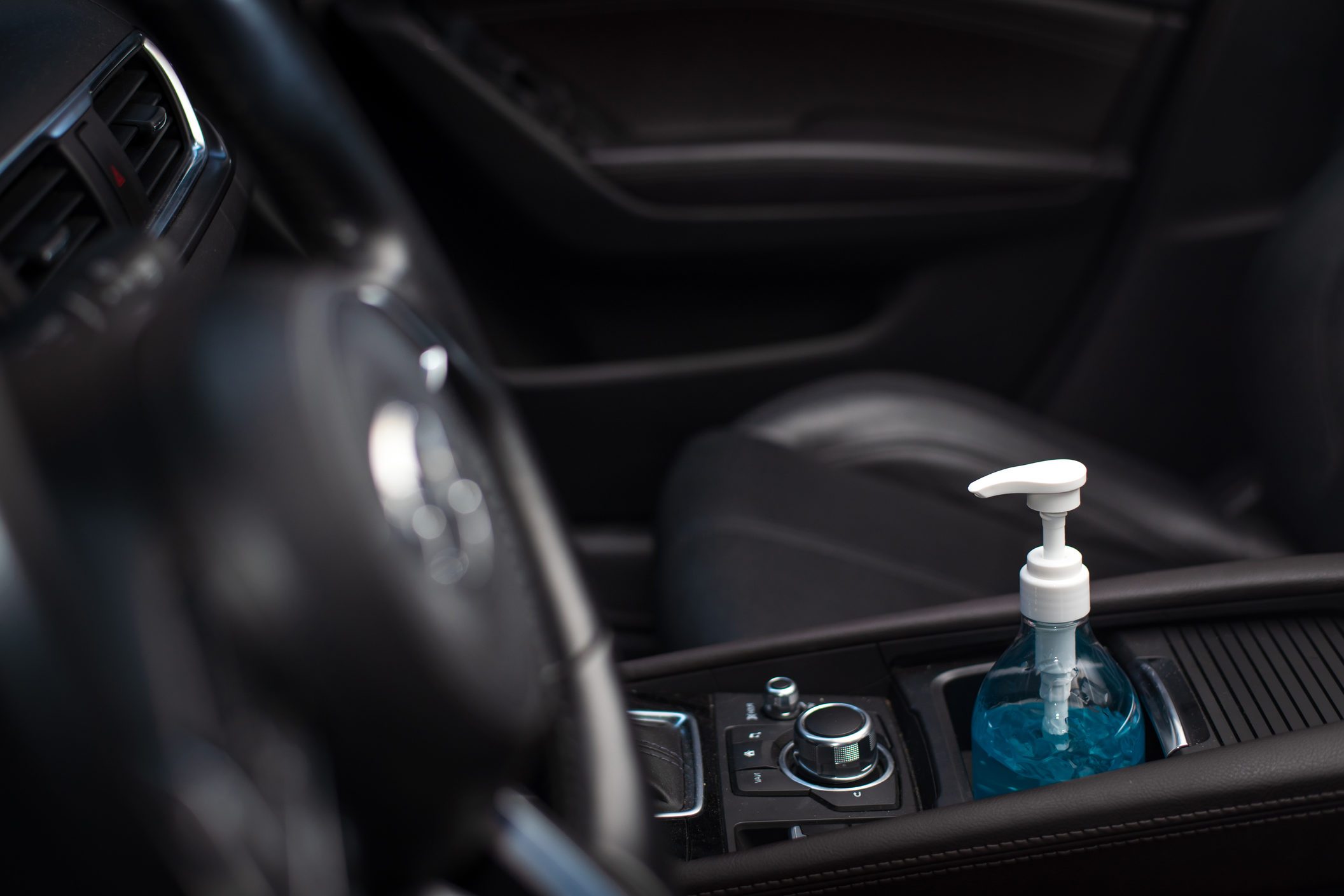 Bottle of blue sanitizer ethyl alcohol hand gel cleanser put in the car, prepare for protecting coronavirus, COVID-19