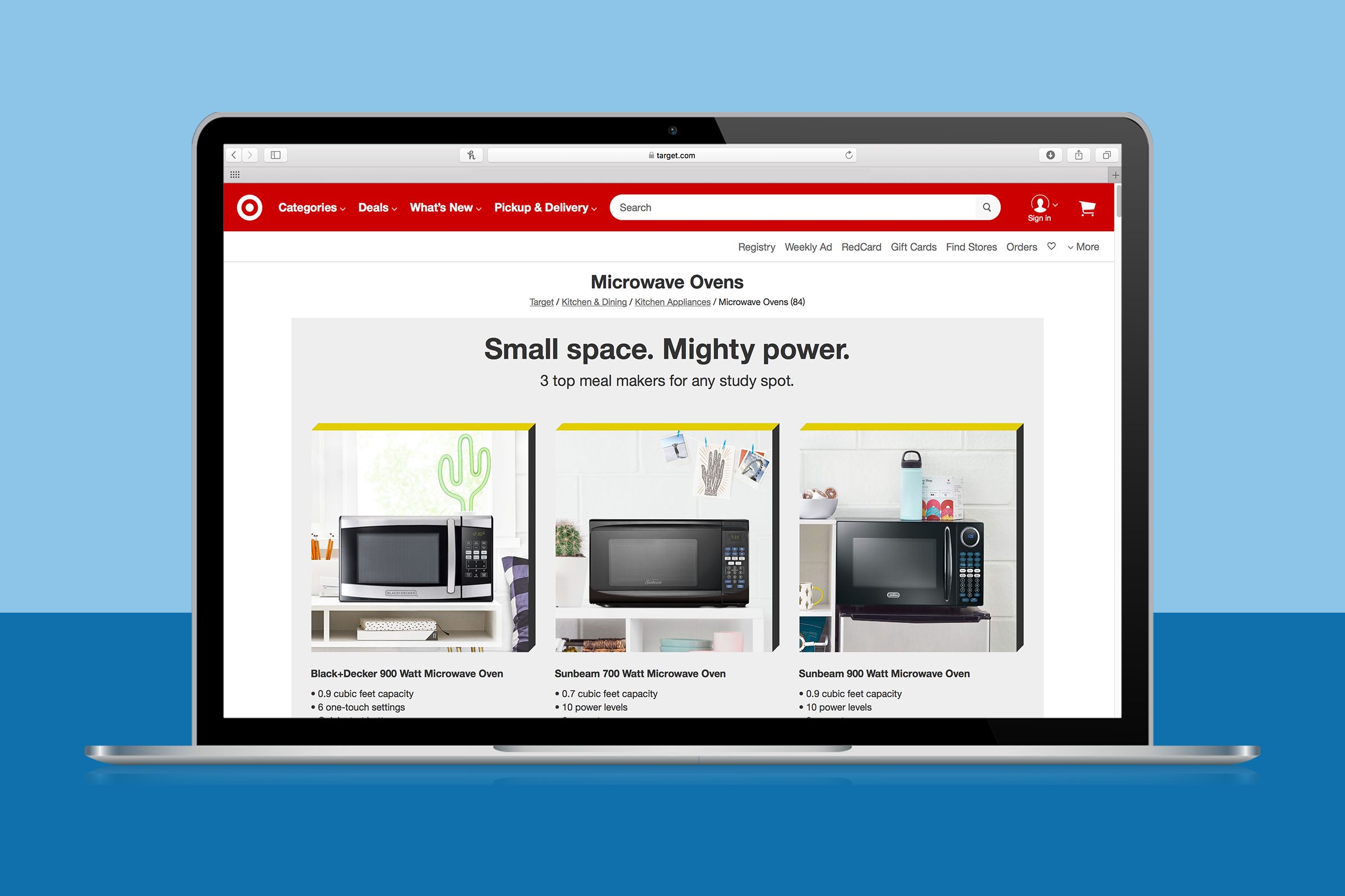 A laptop displays a webpage showing three microwave ovens, each described with model, wattage, and features, against a home-themed background.