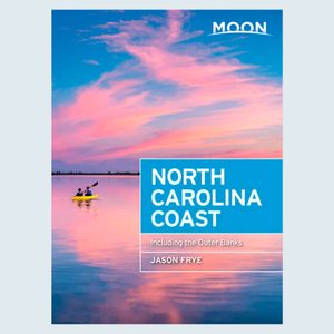 A yellow kayak floats on calm water under a vibrant pink and blue sunset. Text: 