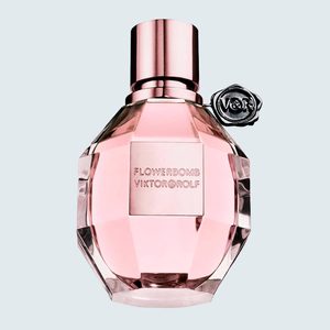 Pink perfume bottle stands upright; embossed with 