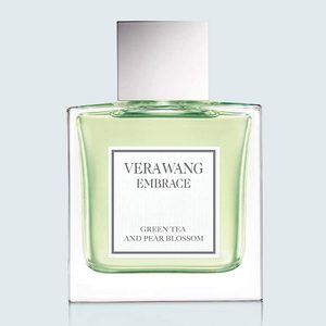 Perfume bottle sits on a flat surface; clear design with 