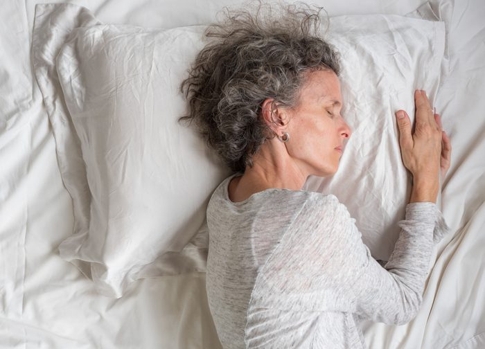 Woman Sleeping On Bed