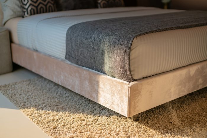 Synthetic carpet on the laminate in the home interior. Close-up